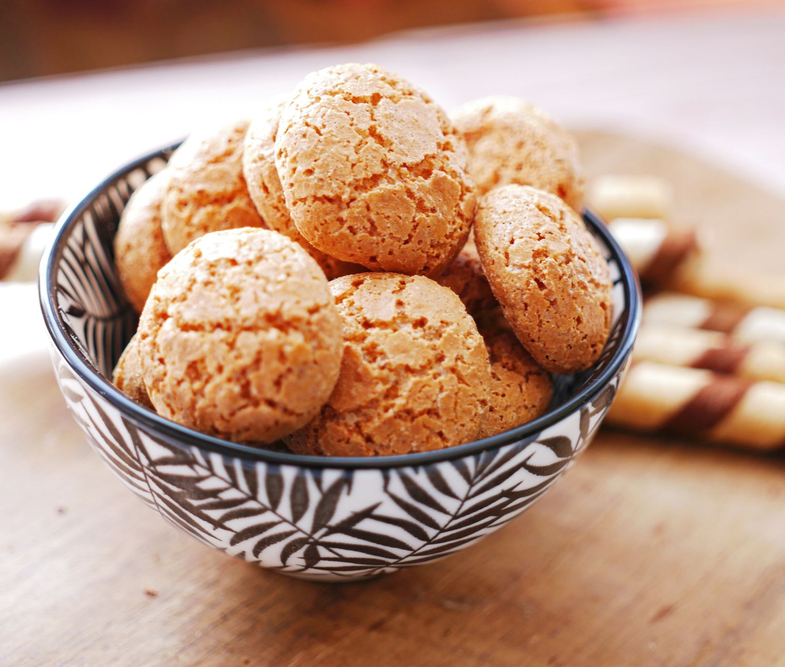 Chewy italian almond cookies with dried cherries on a rustic plate