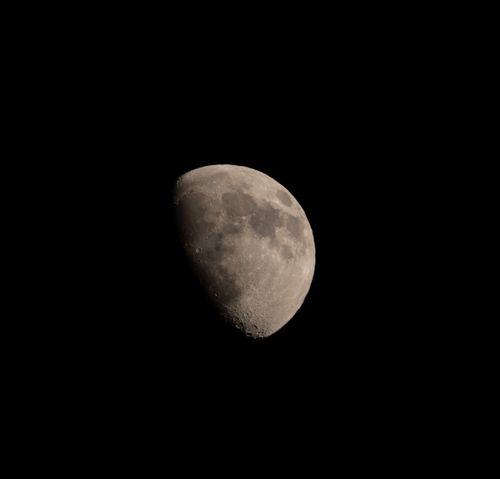 Free Captivating view of a half moon against a dark night sky, showcasing lunar details. Stock Photo