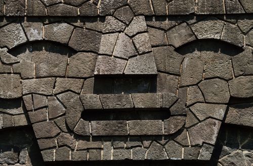 Free Close-up of a stone mosaic depicting a face with intricate textured pattern. Stock Photo