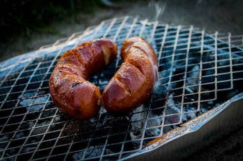 Free Two Sausages on Charcoal Grill Stock Photo