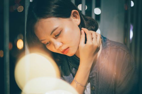 Free A contemplative woman in soft lighting, highlighting pensive mood and fashion style. Stock Photo