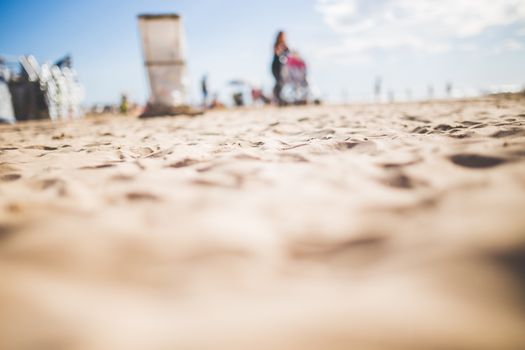 A sandy beach scene captured with a shallow depth of field, highlighting textures.