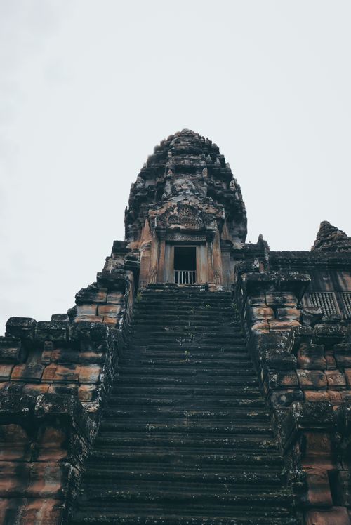 Free Majestic view of Angkor Wat's ancient stone steps against a white sky in Siem Reap, Cambodia. Stock Photo