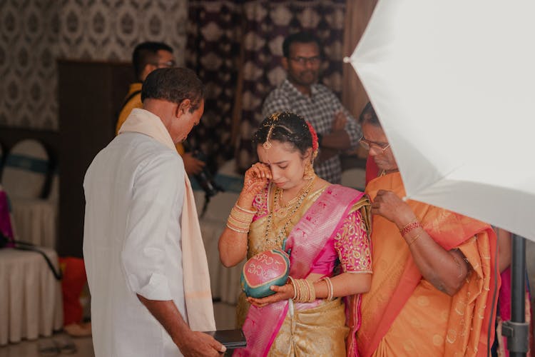 A Bride Crying In Front Of Her Father