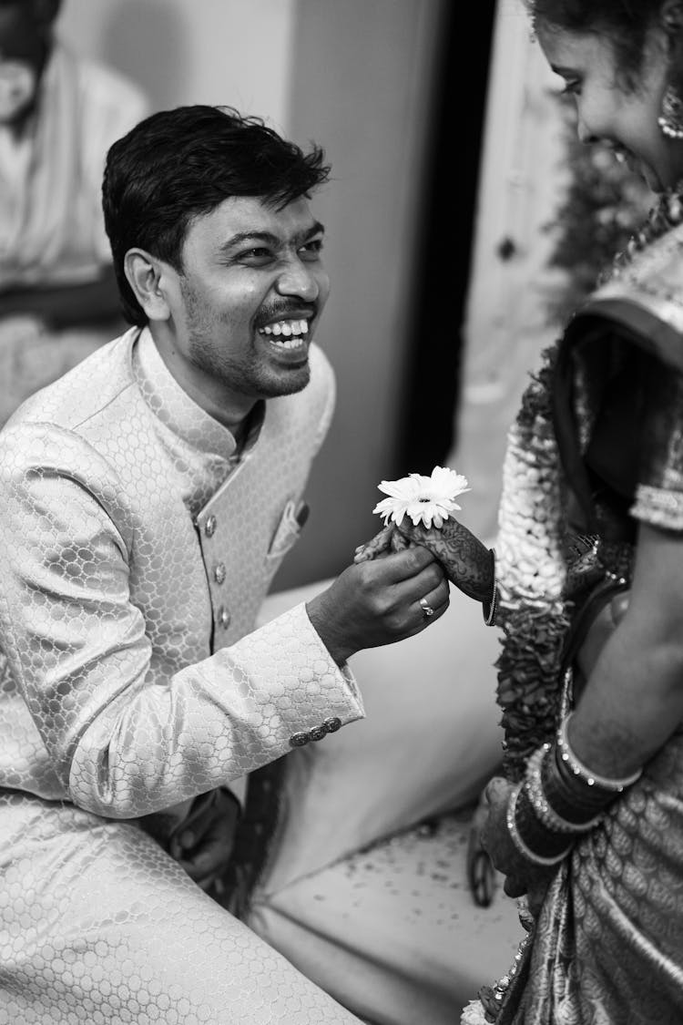 Smiling Man Giving Flower To Woman 