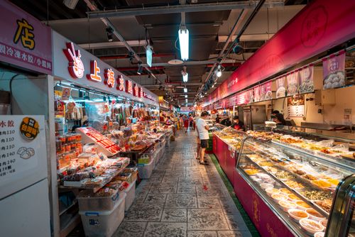 Free Explore a bustling Asian market with colorful food displays and busy shoppers. Stock Photo