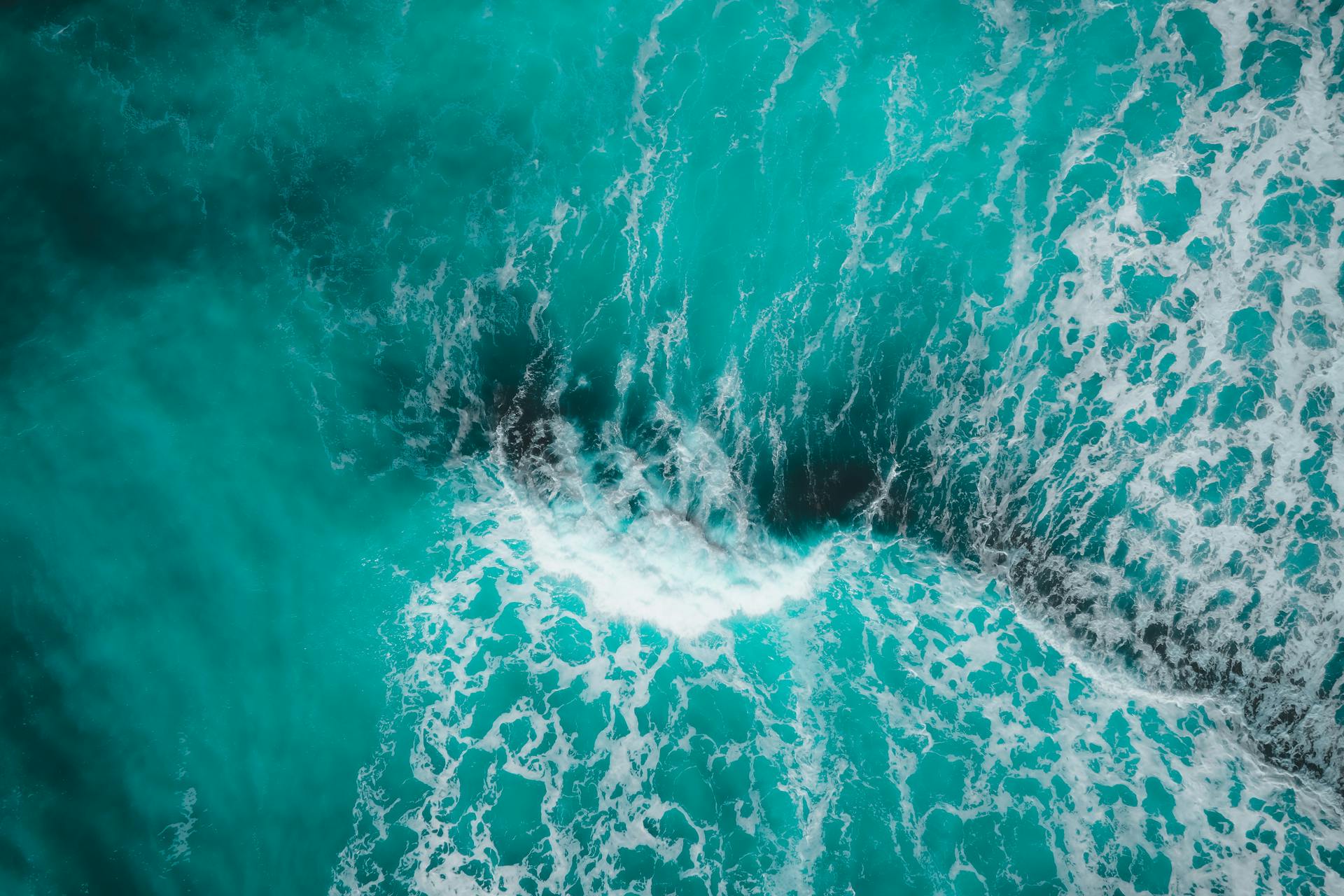 Scenic View of Waves and Foam on a Turquoise Sea