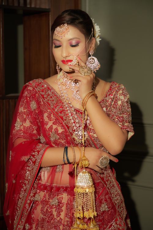 Free Beautiful Indian bride in traditional red lehenga with ornate jewelry. Stock Photo