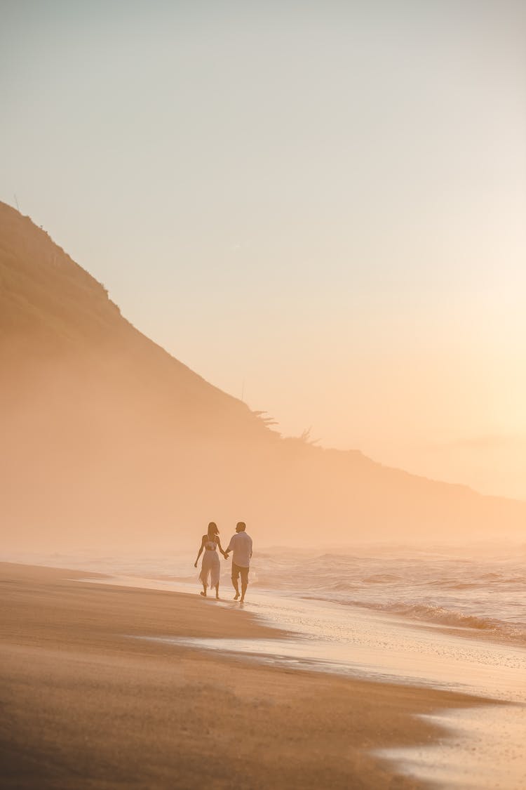 Couple Walking On Beach