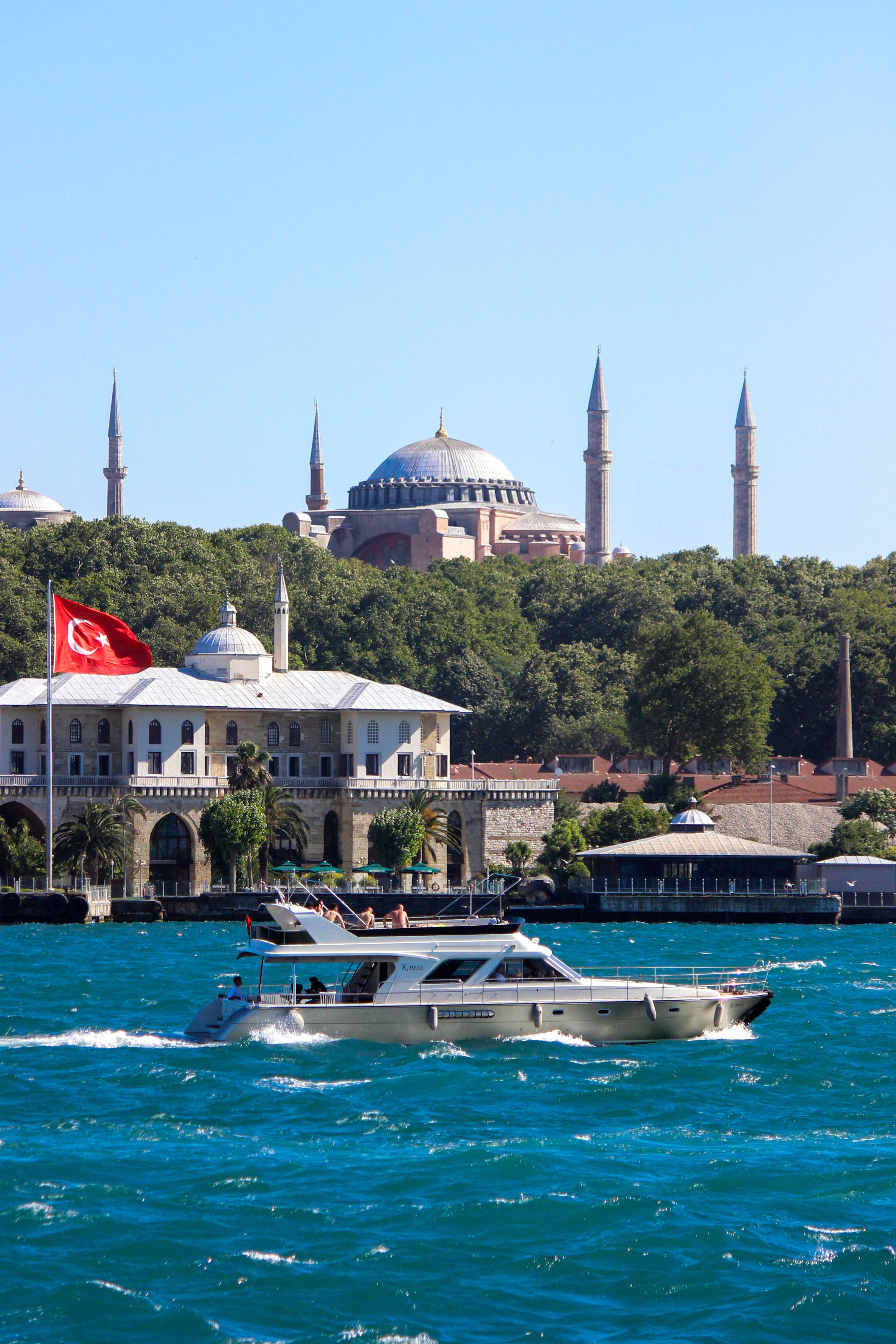 Yacht in Bay with Mosque in Background · Free Stock Photo