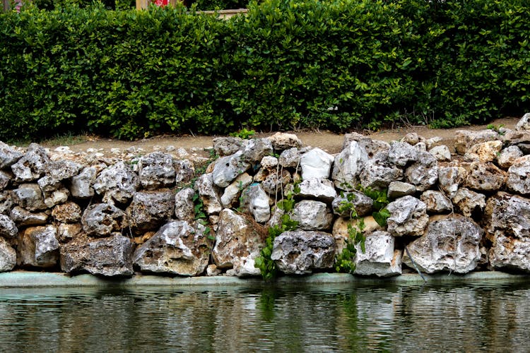 Stone Wall Surrounding An Edge Of A Pond