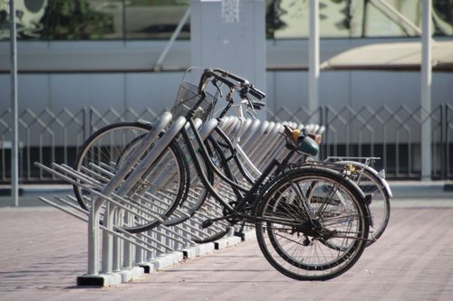 Free Bicycles parked in a modern city bike rack in downtown Dubai, reflecting urban lifestyle. Stock Photo