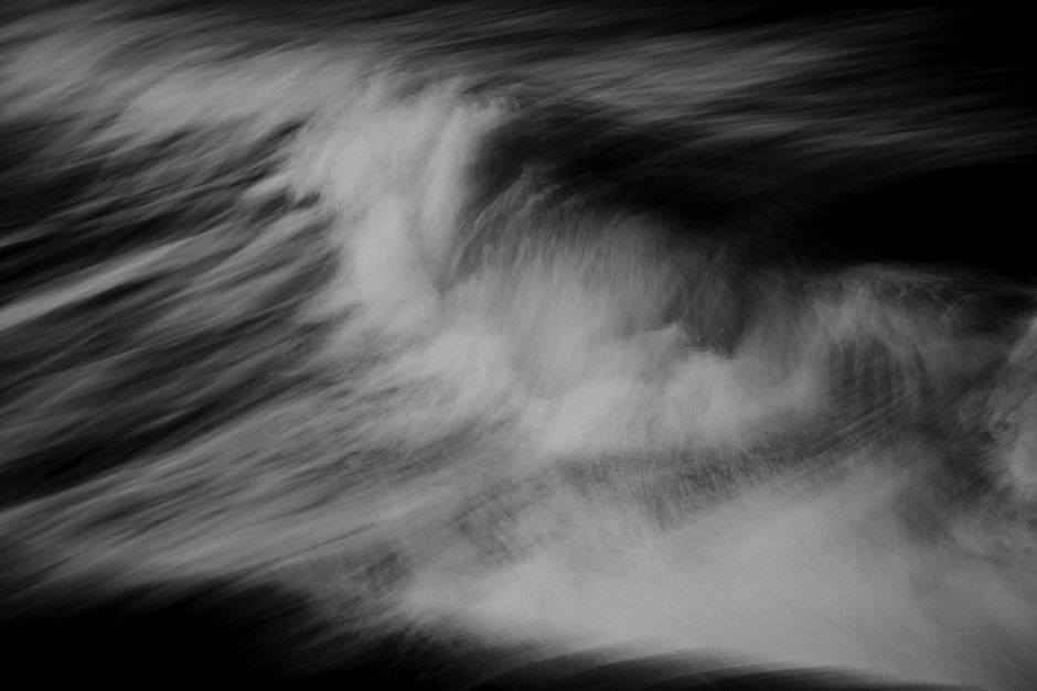 Dynamic black and white ocean wave captures the raw energy and motion of nature.