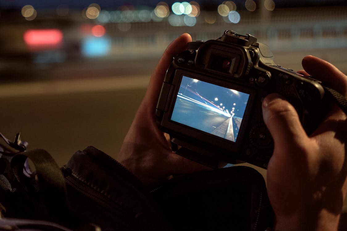 Person Holding Dslr Camera