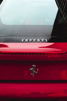 Close-up shot of a red luxury car featuring a chrome tail light and badge.