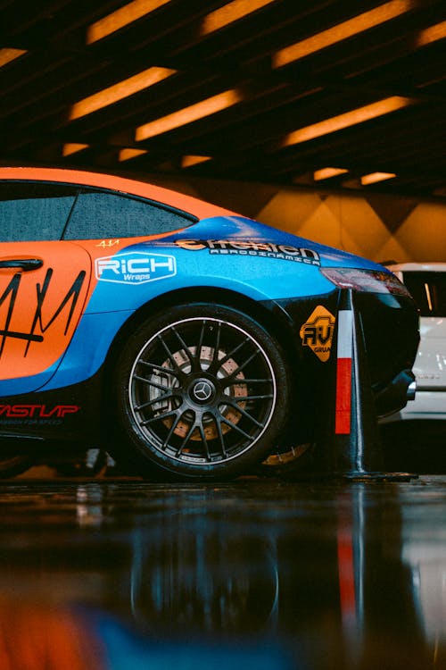 Blue and Orange Car Parked in the Garage