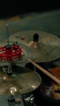 Detailed vertical shot of cymbals in a drum set, showcasing percussion elements.