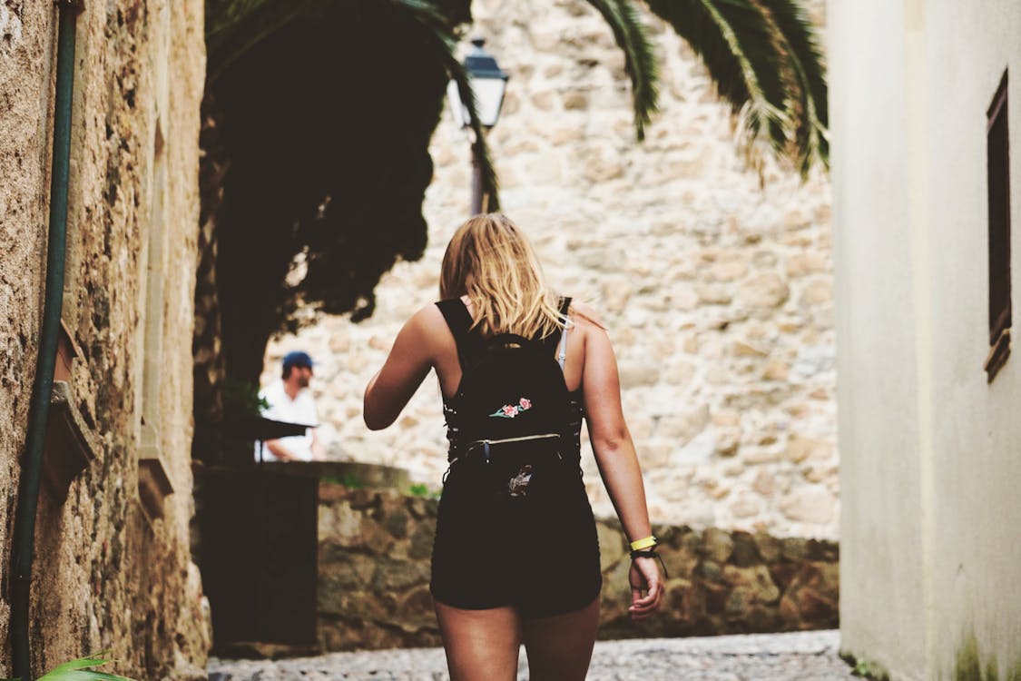 Free Woman Walking on Alley Stock Photo