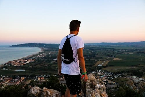 Homem Usando Bolsa Com Cordão No Topo Da Montanha