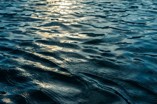 Free Calm ocean water with gentle ripples reflecting sunlight during the day. Stock Photo
