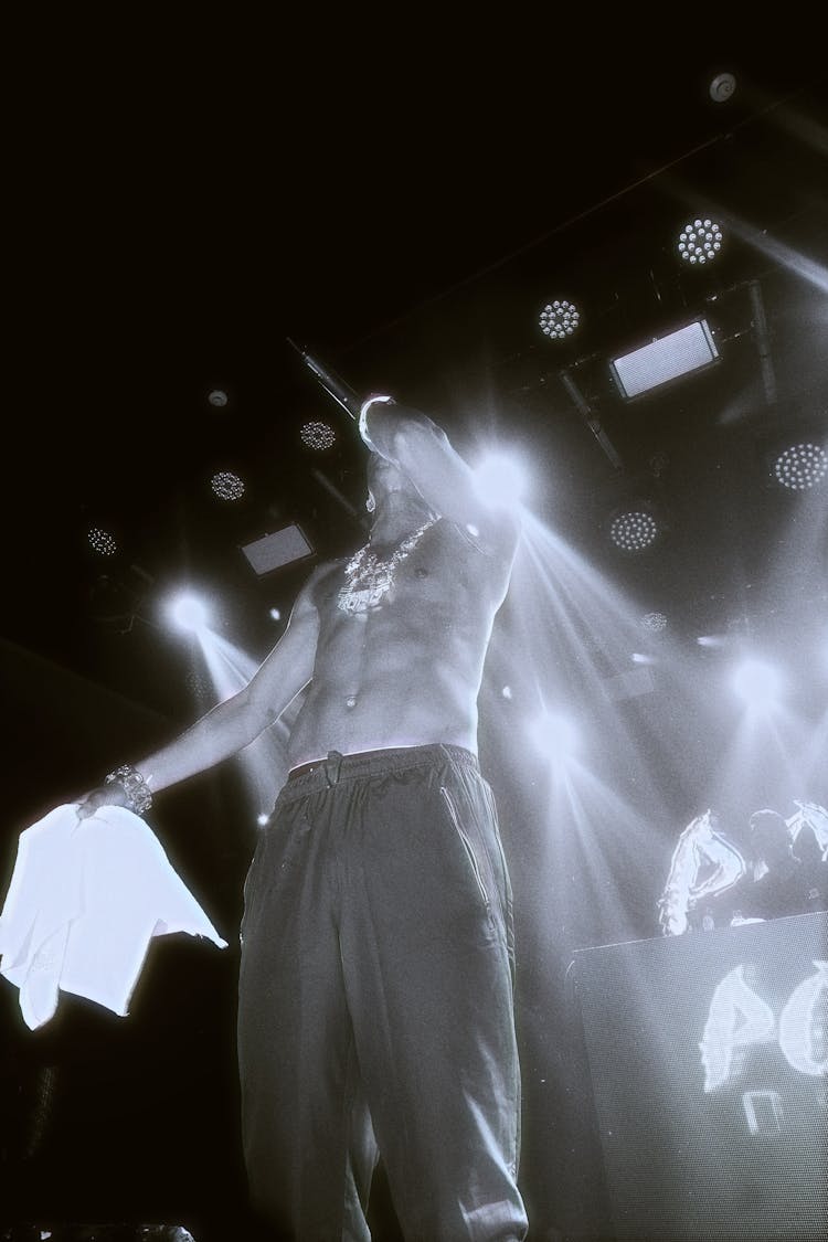 Low Angle View Of A Singer Standing On A Stage And Keeping White Towel And A Microphone