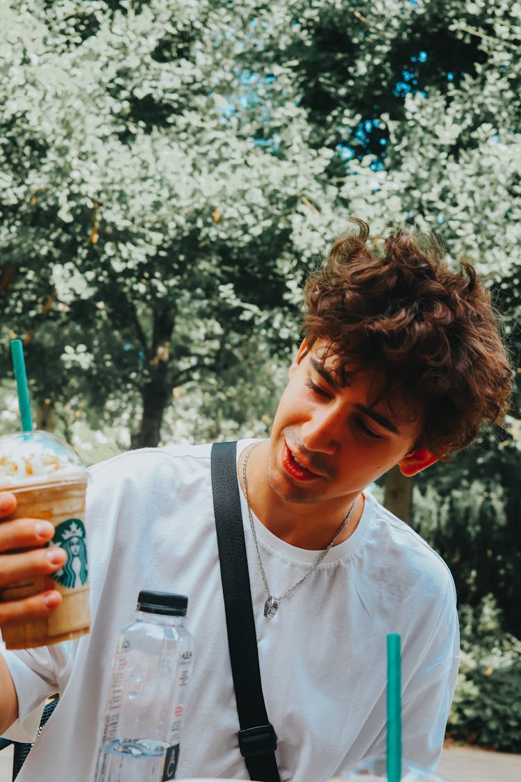 Man In White Crew Neck Shirt Holding A Coffee Drink