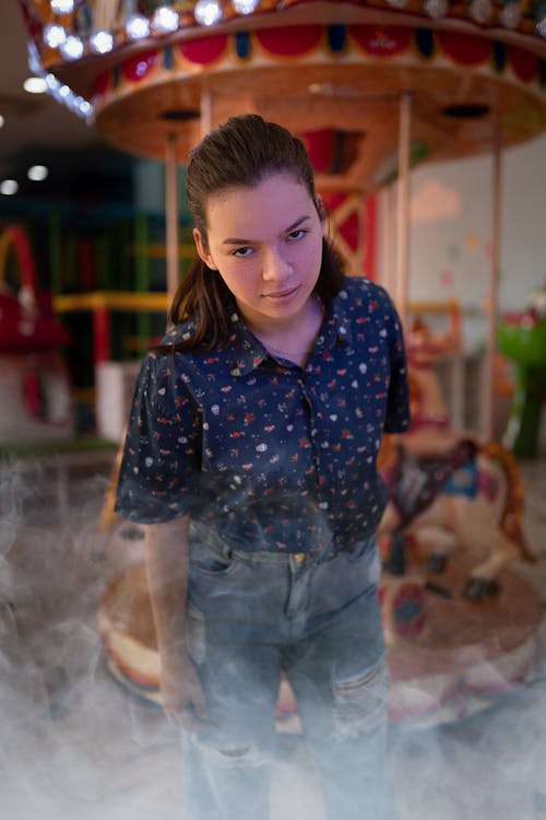 Woman Standing against Carousel