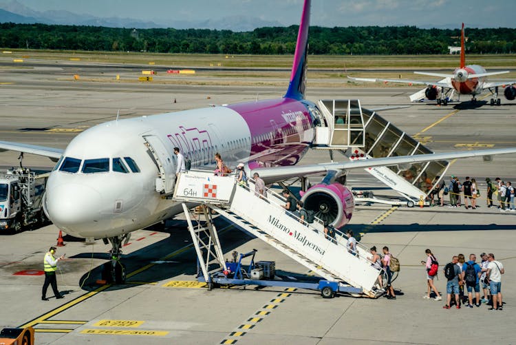 Passengers Boarding An Airplane