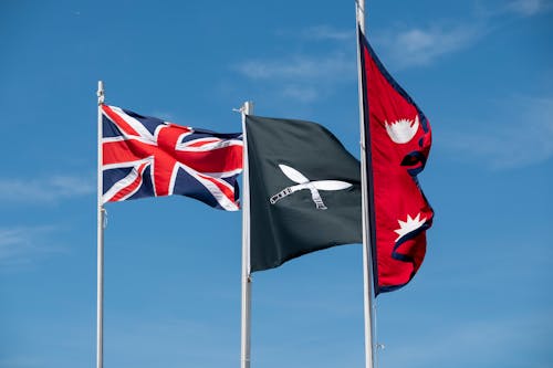 Nepal and United Kingdom Flags on Wind