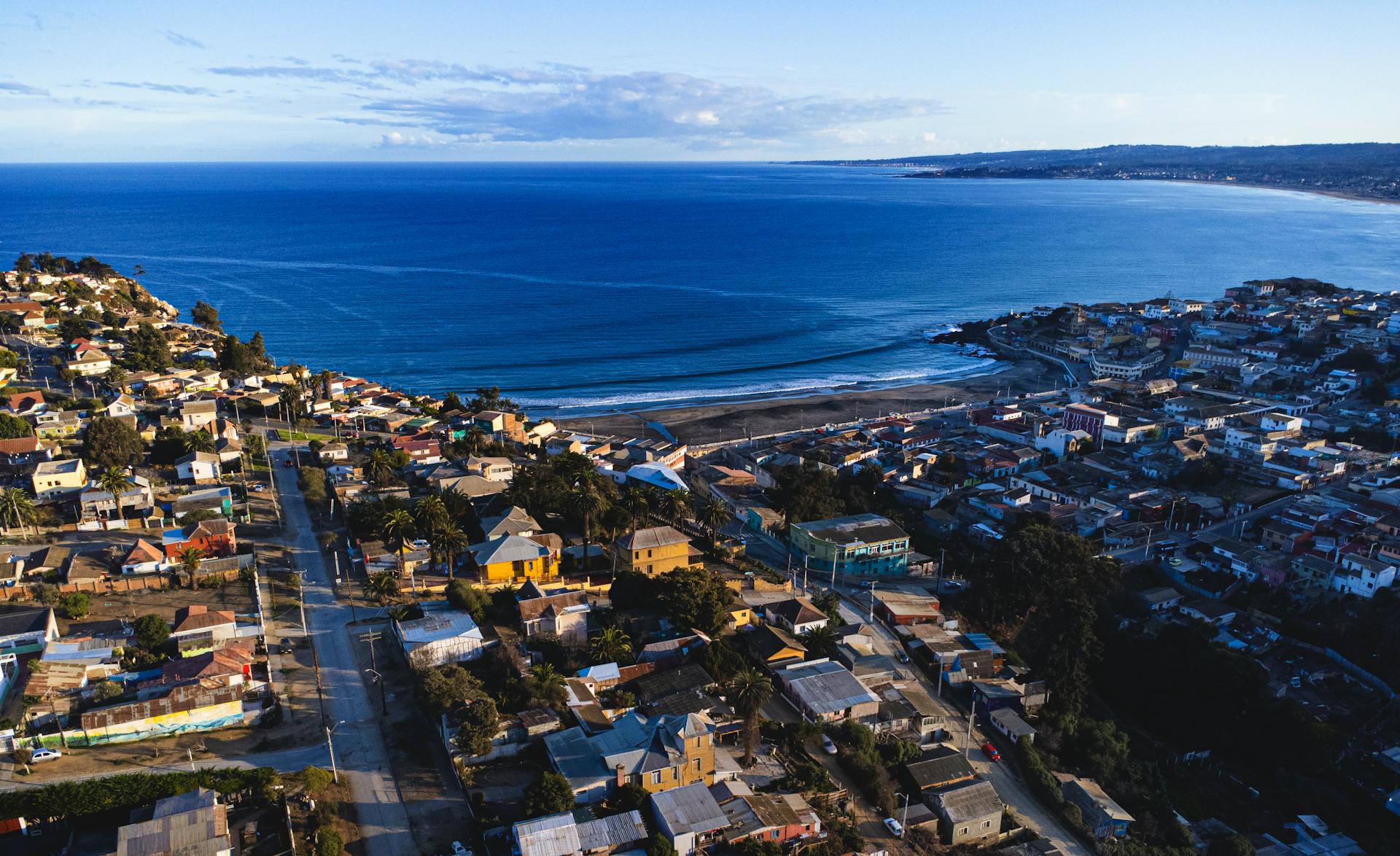 Aerial view capturing beautiful coastal Cartagena with houses, beach, and ocean.