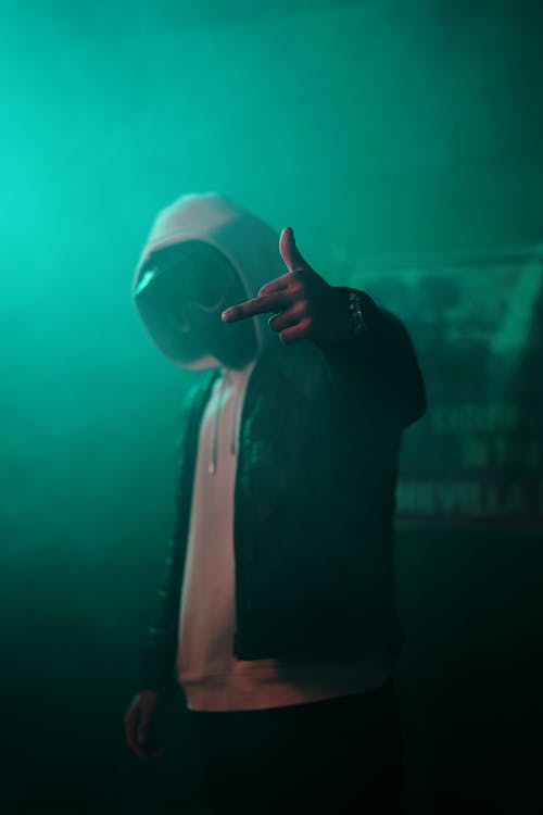 Man in Hood Showing Middle Finger