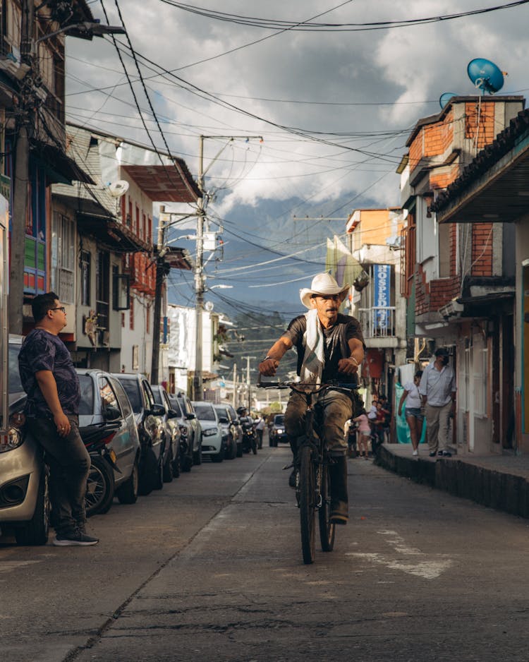 Man Riding A Bicycle On A City Street