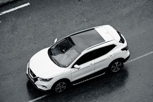 White crossover seen from above on a wet street — photo by Crab Lens on Pexels