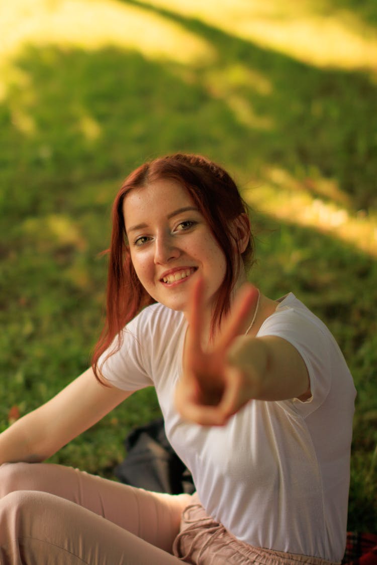 Redhead Girl Showing V Sign With Fingers