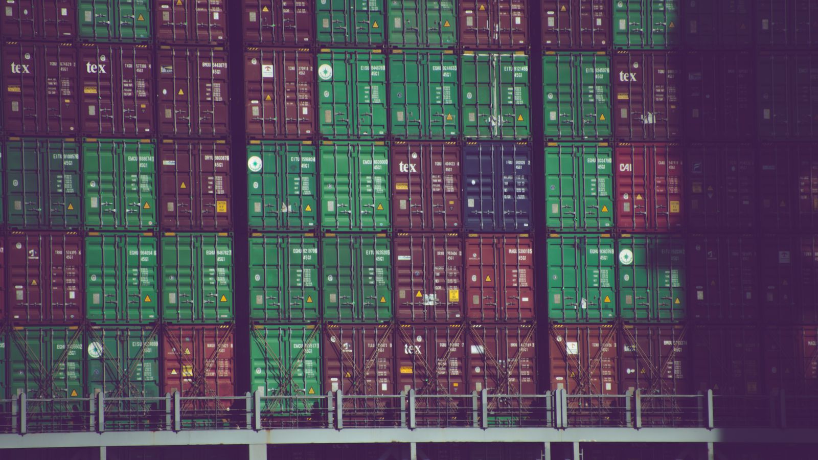 Vibrant cargo containers stacked at Hamburg port, Germany, showcasing global trade.