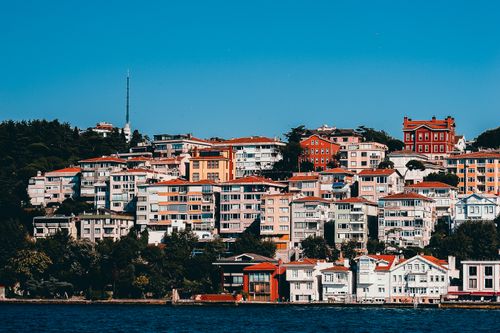Free Charming hillside view of colorful buildings by the water on a sunny day. Stock Photo