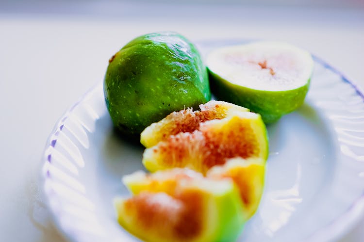 Sliced Green Fruit On White Ceramic Plate