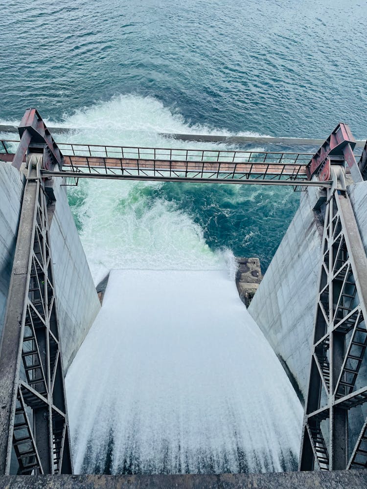 Water Flowing Through Gates Of A Dam