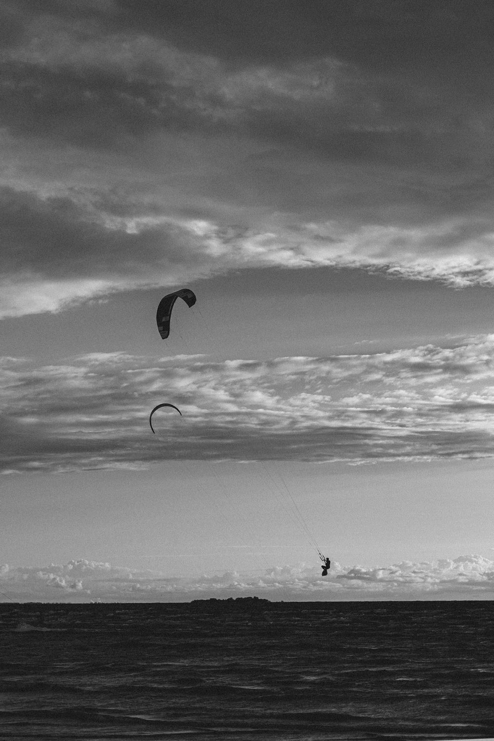 Kitesurfer silhouette against sunset