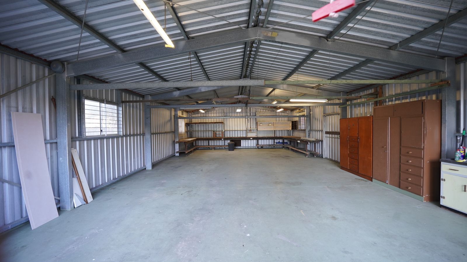 Empty steel shed with a smooth, clean concrete floor slab