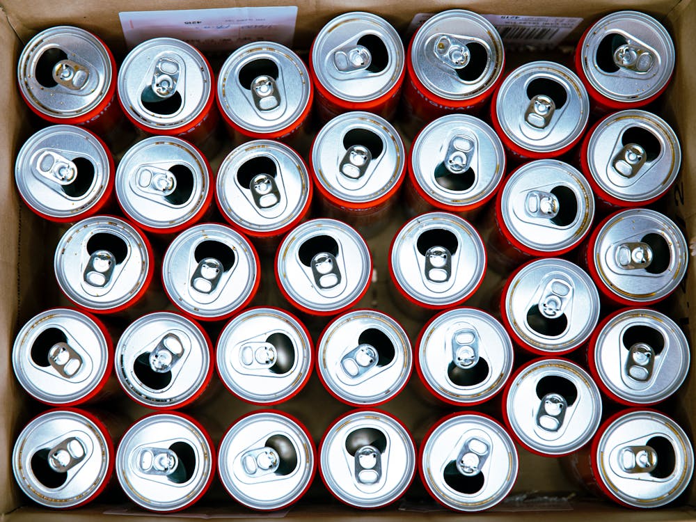 Empty Soda Cans on a Cardboard Box