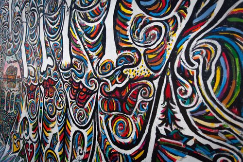 Free Colorful abstract mural art depicting swirling patterns on the Berlin Wall. Stock Photo