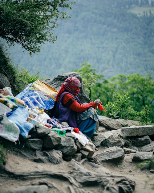 A Person Sitting on Gray Rock