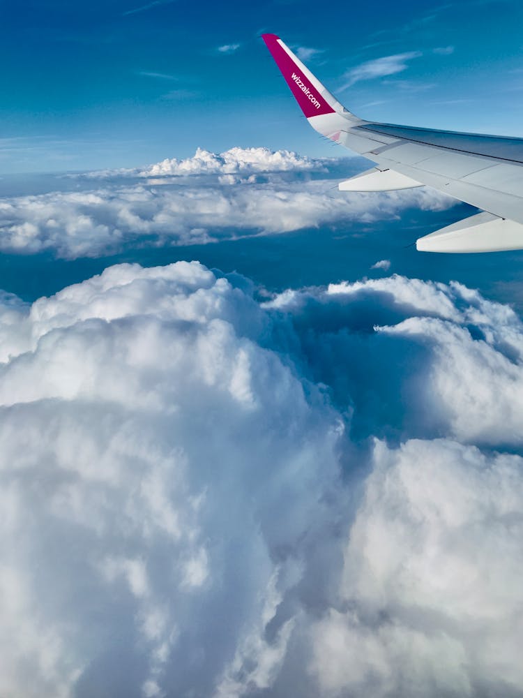 Plane Wing In Clouds In Sky