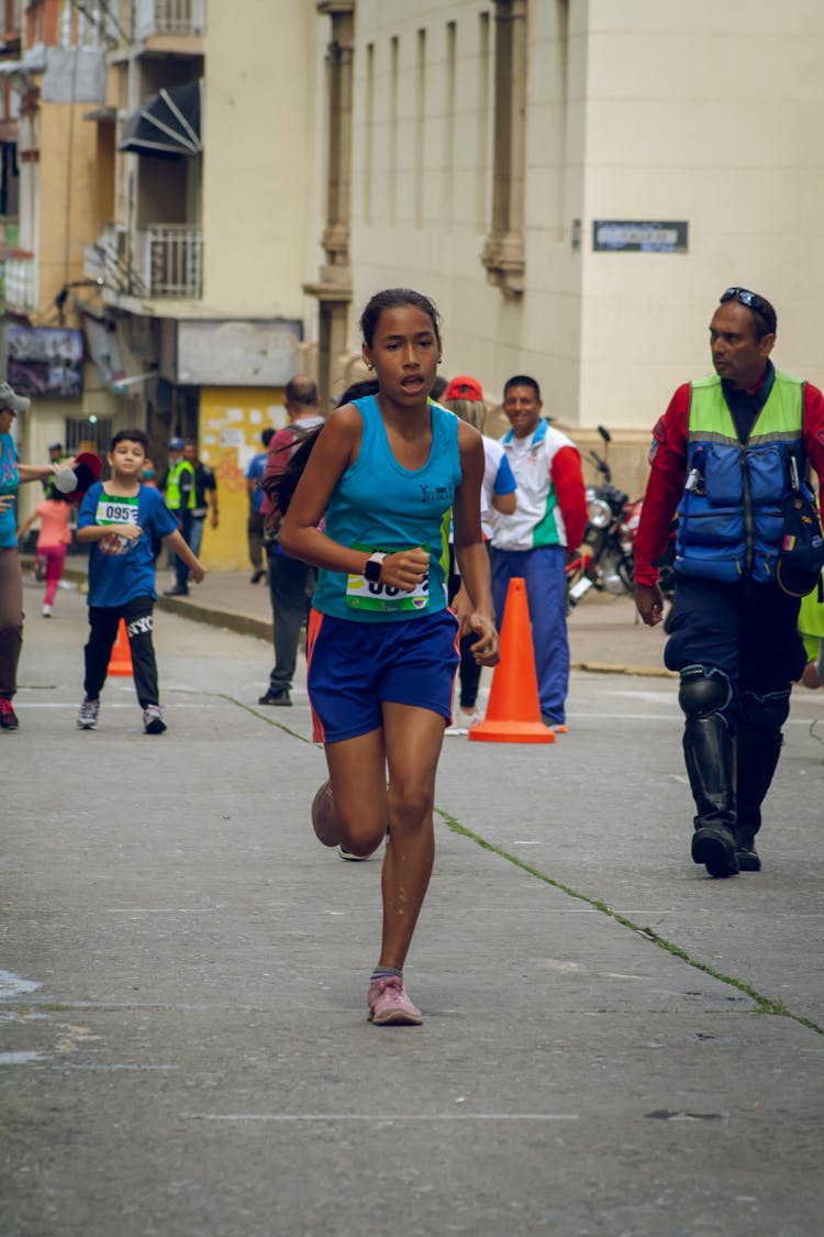 Woman In Sportswear Running On A Marathon Race 