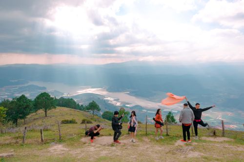 Free A group of friends having fun on a mountain hike with stunning landscape views. Stock Photo