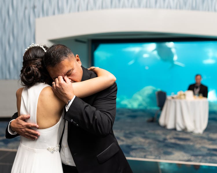 A Father Hugging His Daughter In Her Wedding Day