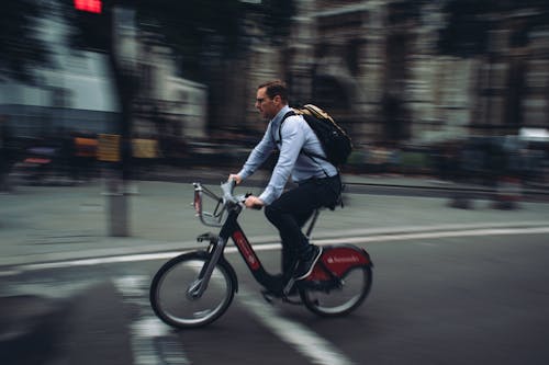 Man Riding a Bicycle in the City 