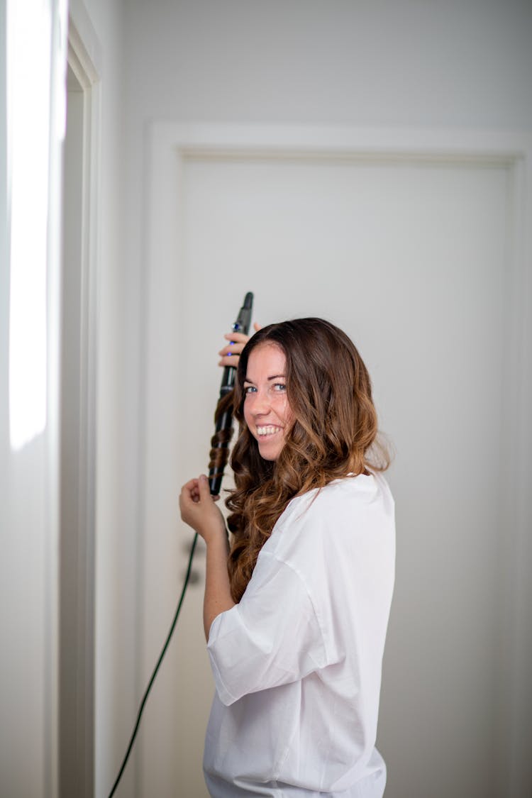 Woman Holding A Hair Curler