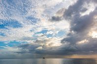 A stunning cloudy sky over the tranquil ocean in Grenada, showcasing nature's beauty.